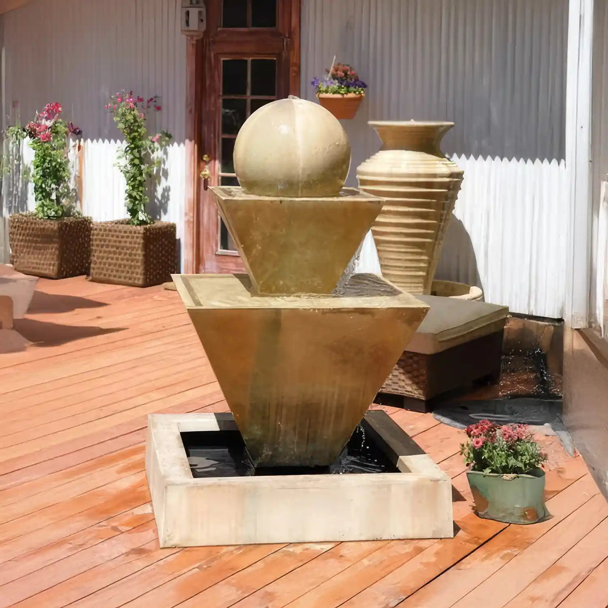 Gist Double Oblique Fountain with Ball in tan, shown on a wood deck