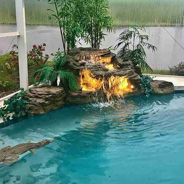 Paradise Falls pool waterfall with natural rock design and cascading water.